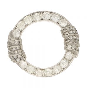 Art Deco Openwork Diamond and Platinum Brooch 5.25cts; openwork platinum hoop set with 5.25 carats of old mine cut and old European brilliant cut diamonds, accented with two fan-shape motifs set with single cut and rose cut diamonds