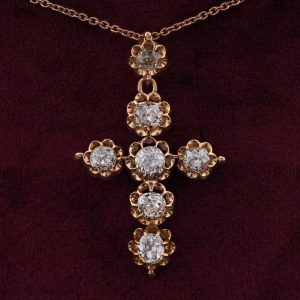 Antique Victorian 5.1ct Old Mine Cut Diamond Cross Pendant; claw-set with seven old mine-cut diamonds in fluted 18ct yellow gold settings. Late 19th century Circa 1880-1890