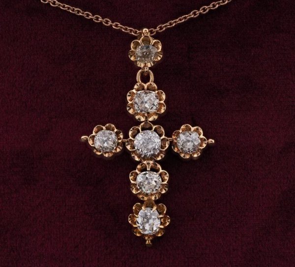 Antique Victorian 5.1ct Old Mine Cut Diamond Cross Pendant; claw-set with seven old mine-cut diamonds in fluted 18ct yellow gold settings. Late 19th century Circa 1880-1890