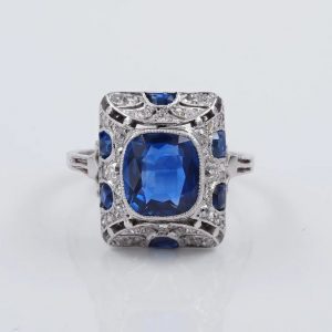 Art Deco French Burma Sapphire and Diamond Cocktail Ring in Platinum; central certified natural no heat 2.81ct cushion-cut Burmese sapphire within pierced platinum frame decorated with 1.10cts old mine-cut and rose-cut diamonds with 0.60cts calibre sapphire accents. Made in France, Circa 1920