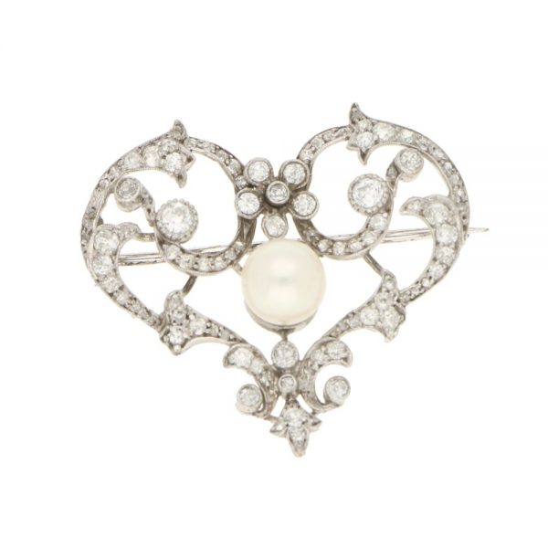 Antique Edwardian Pearl and Diamond Openwork Heart Brooch in Platinum; central 7.9mm pearl surrounded by 1.87cts old mine-cut, old European-cut, single-cut and rose-cut diamonds with stylised scrolled and floral motifs
