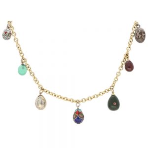 Vintage Russian Egg Fringe Necklace in Gold and Silver; solid 9ct yellow gold chain which suspends seven antique Russian eggs including silver, enamel, chrysoprase, nephrite jade with rubies, and rhodolite eggs