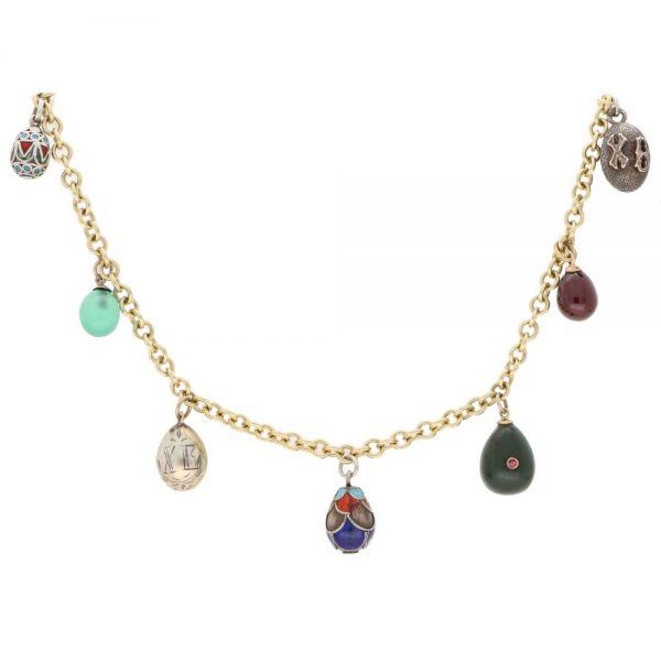 Vintage Russian Egg Fringe Necklace in Gold and Silver; solid 9ct yellow gold chain which suspends seven antique Russian eggs including silver, enamel, chrysoprase, nephrite jade with rubies, and rhodolite eggs