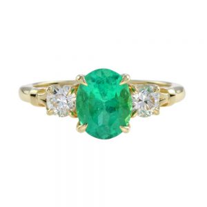 2.03ct Oval Emerald and Diamond Three Stone Ring in 18ct Yellow Gold; central 2.03ct oval emerald flanked by 0.56cts old-cut diamonds in 18ct yellow gold