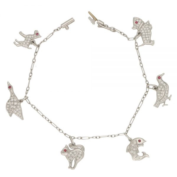 Vintage 1950s Animal Platinum Charm Bracelet with Diamonds and Rubies; six diamond-set charms with a ruby eye; a dog, grouse, fish, cat, duck and foul, 1.03 carats