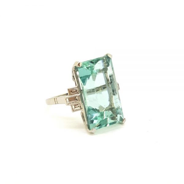 18.35ct Aquamarine and Diamond Dress Ring; stunning 18.35 carat sea green/blue aquamarine with baguette diamonds to each shoulder in platinum