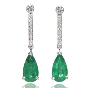A pair of diamond topped emerald drop earrings mounted in platinum, the Brazilian emeralds with a combined weight of 2.51 carats