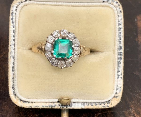 Antique emerald engagement ring cluster with diamonds