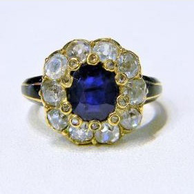 Antique Victorian 1ct Sapphire and Old Cut Diamond Cluster Ring with Enamel Shoulders in 18ct yellow gold. English, Circa 1850