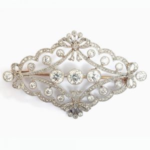 Antique Edwardian Old Cut Diamond Brooch, set with old European-cut diamonds within a rose cut diamond border designed as a quatrefoil of bows in platinum upon gold