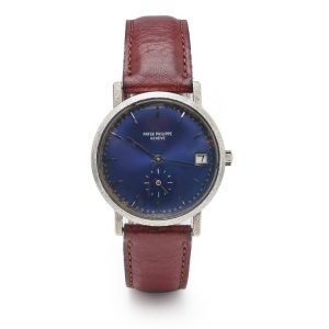 Vintage 1970s Patek Philippe Calatrava 18ct White Gold 3558 Manual Watch; blue dial with baton hour markers and date aperture at the 3 o'clock position on a brown leather strap. Comes in Patek Philippe watch box and Patek Philippe Extract from the archives