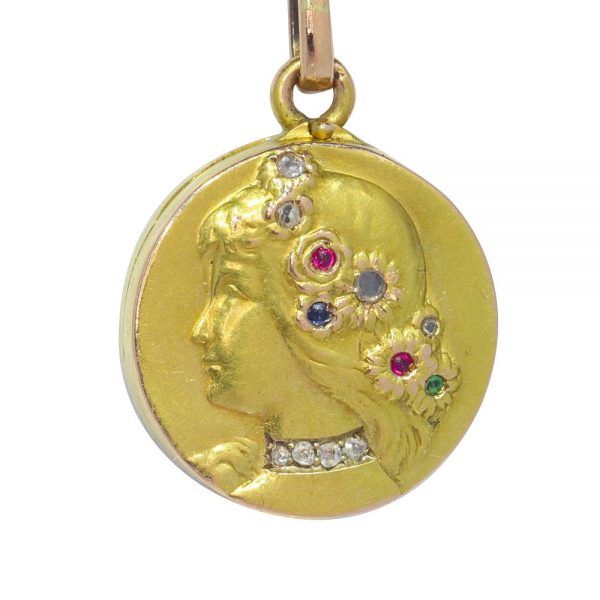 Art Nouveau gold locket with diamonds and gemstones.