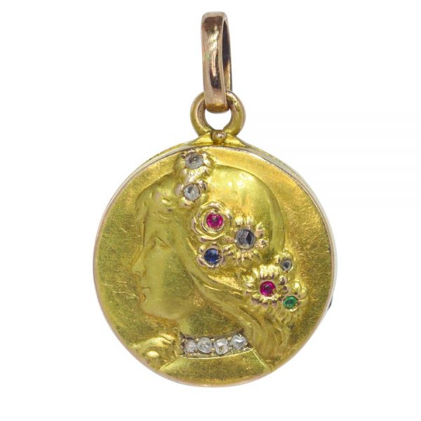Art Nouveau gold locket with diamonds and gemstones.