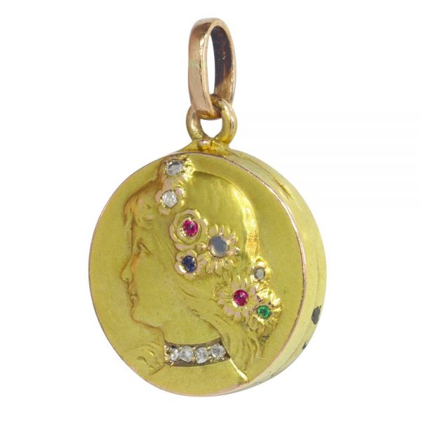 Art Nouveau gold locket with diamonds and gemstones.