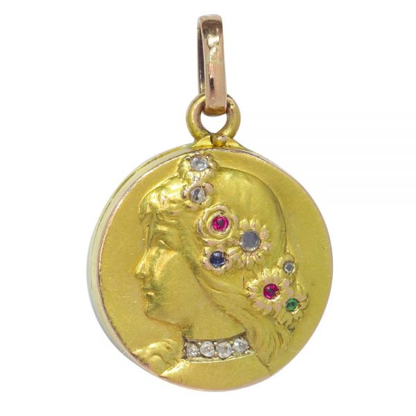 Art Nouveau gold locket with diamonds and gemstones.
