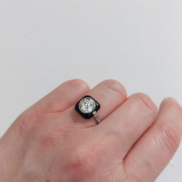 Art Deco onyx and diamond ring on model hand finger