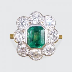 Contemporary 0.90ct Emerald and Diamond Cluster Ring