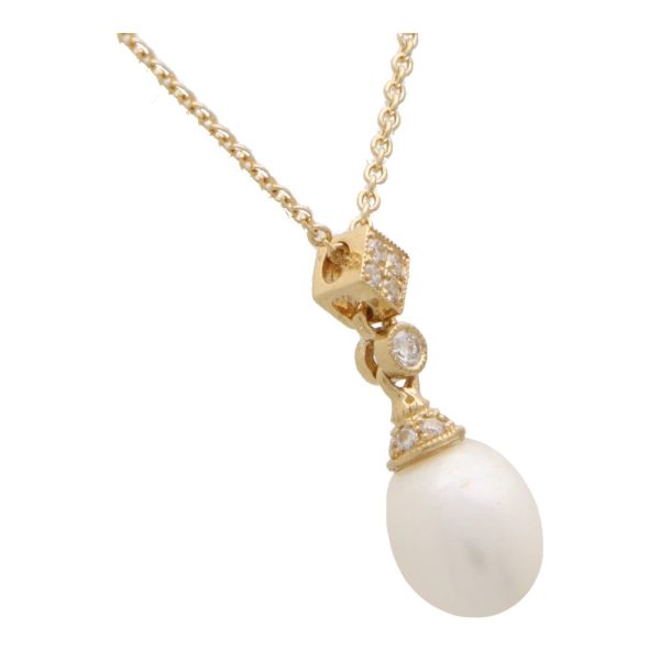 Pearl and Diamond Drop Pendant Necklace in 18ct Yellow Gold, 8 x 10mm pearl hangs from a diamond set cap and stylized diamond bail on 16-18-inch yellow gold trace chain