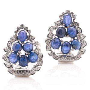 Natural Cabochon Sapphire and Diamond Cluster Earrings, 18ct white gold clip-on earrings in the form of a leaf adorned with 7.20cts beautiful natural oval blue cabochon sapphires and 0.90cts round brilliant diamonds. Circa 1990s