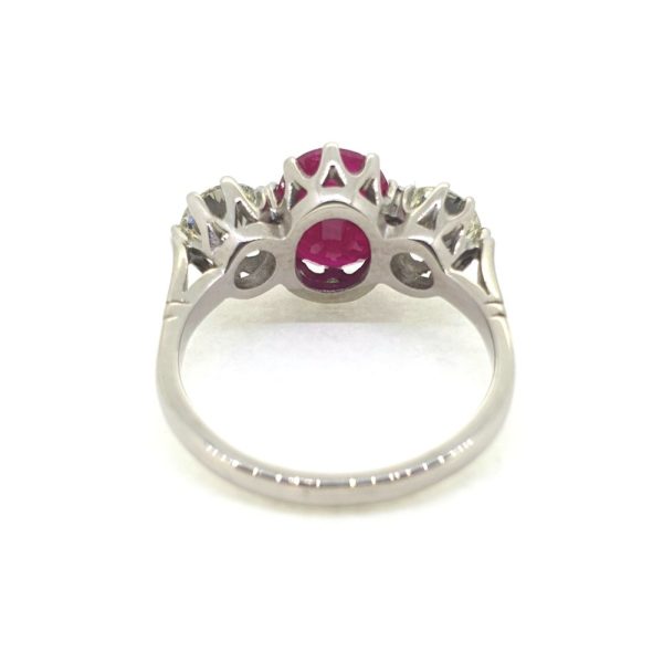 3.75ct Oval Ruby and Diamond Three Stone Engagement Ring in Platinum, central 3.75ct oval red ruby flanked by 1.44cts round brilliant-cut diamonds