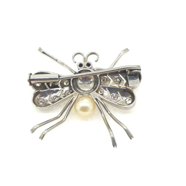 Vintage Pearl and Diamond Set Platinum Insect Brooch, insect/bug/fly brooch crafted in platinum with diamond-set wings a pearl body and red gem-set eyes