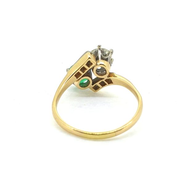 Vintage Emerald and Diamond Toi et Moi Two Stone Crossover Engagement Ring, Showcasing a 0.65ct diamond and emerald between diamond detailed bars in platinum upon 18ct yellow gold