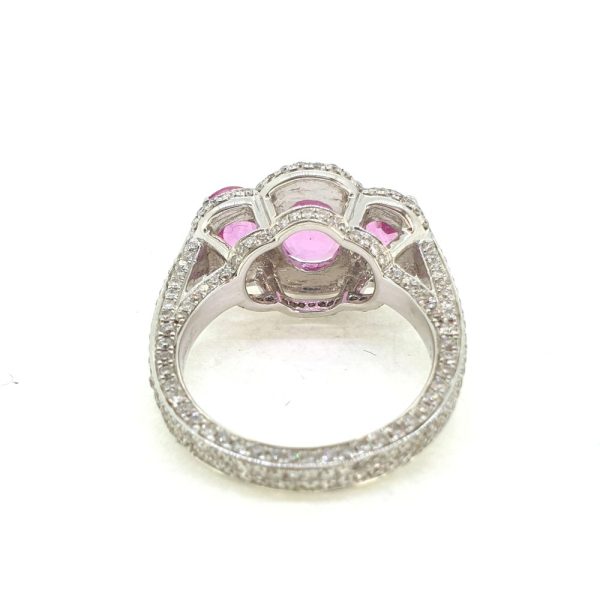 Pink Sapphire and Diamond Triple Cluster Dress Ring, Three oval pink sapphires bordered by round brilliant-cut diamonds in 18ct white gold with a double line of diamonds to each shoulder