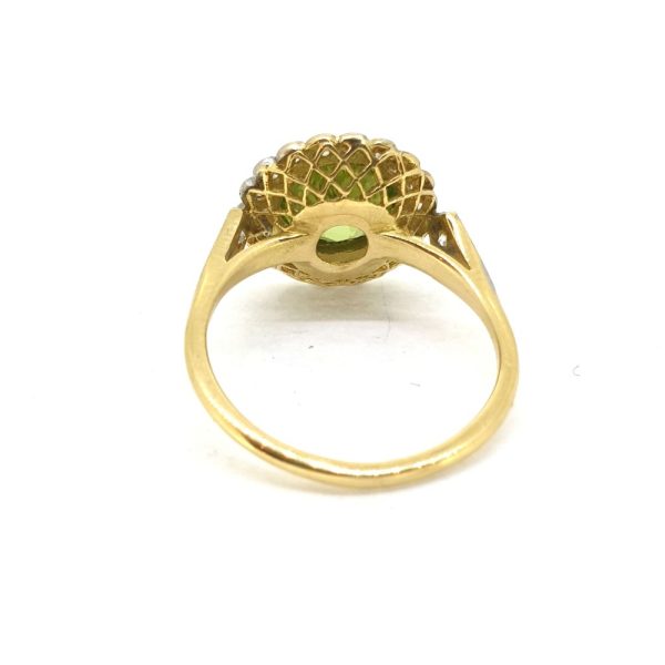 Peridot and Diamond Cluster Dress Ring, 1.80ct round peridot surrounded by 18 round brilliant-cut diamonds in 18ct yellow gold with millegrain edging