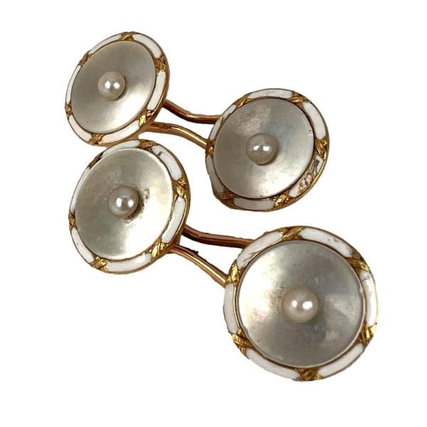 French Gold Mother of Pearl and Enamel Cufflinks, 18ct yellow gold cufflinks designed as convex mother-of-pearl discs with central natural seed pearls and edged with white enamel