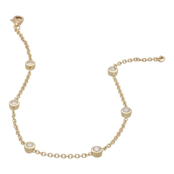 Contemporary Diamond Set Yellow Gold Chain Bracelet, 14ct yellow gold trace chain bracelet interspersed with six bezel set round brilliant-cut diamonds totalling 0.55 carats