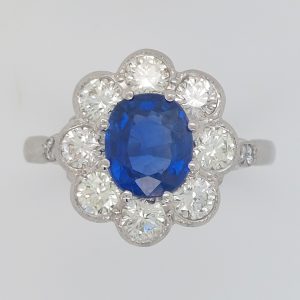 Oval Sapphire and Diamond Cluster Engagement Ring in Platinum