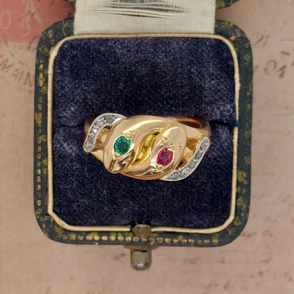 Antique Gem Set Double Snake Ring, set with an emerald and ruby to each head and diamond set tails in 18ct yellow gold and the snakes entwin to make a double shank