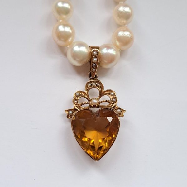 Vintage Pearl Necklace with Citrine Heart Pendant, Edwardian yellow gold citrine heart shaped pendant decorated with micro pearl bow top, suspended from a vintage pearl necklace with 9ct gold and garnet clasp