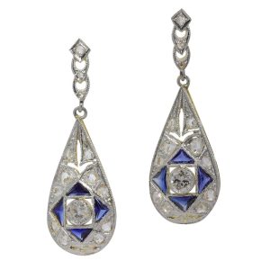 Art Deco teardrop earrings. Principal old mine brilliant cut diamonds surrounded by sapphires, rose cut diamonds and senailles set in two tones of precious metal.