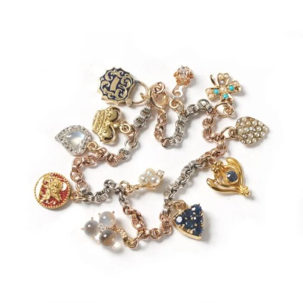 Vintage Multi Gemstone Enamel Gold Platinum Charm Bracelet, bi-colour rose gold and platinum chain suspend charms set with diamond, pearl, moonstone, sapphire, turquoise and enamel