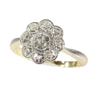 This vintage 1920's Art Deco diamond cluster engagement ring is set in platinum and 18 carat yellow gold. 
