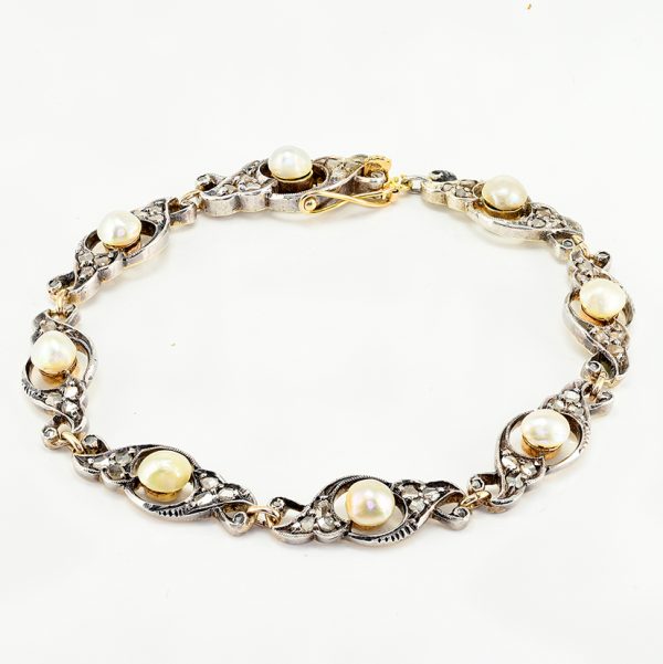 Edwardian Antique Natural Pearl and Rose Cut Diamond Bracelet, openwork scroll links set with rose-cut diamonds around natural pearls in silver upon 18ct yellow gold. Circa 1905