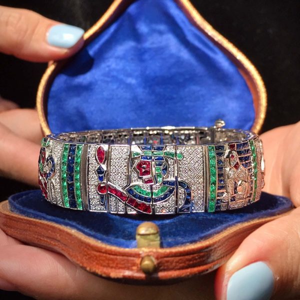 Diamond and Multi Gemstone Egyptian Revival Bracelet, with diamonds, blue sapphires, red rubies, green emeralds and black onyx in 18ct white gold
