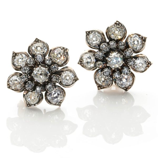 Antique flower design diamond cluster clip earrings in silver and gold.