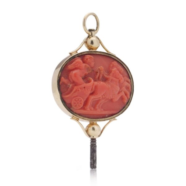 Victorian pocket watch key/pendant in gold and carved coral showing neoclassical scenes.