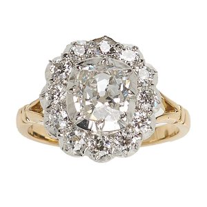 Diamond cluster ring mounted in platinum and gold. Principal diamond 1.06 ct surrounded by 12 diamonds 0.66 ct. 