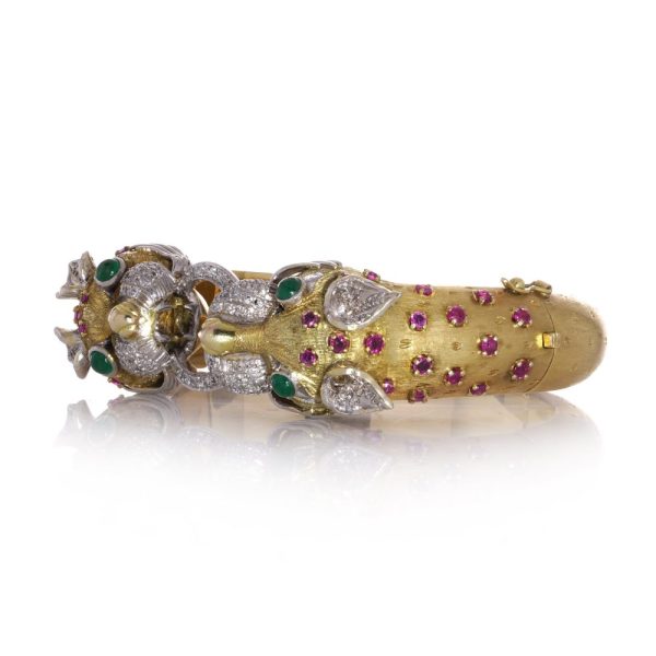 Larry dragon head gold bangle with diamonds, emeralds, and rubies.