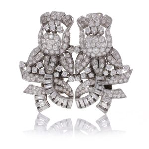 Diamond, platinum and gold double-clip/pendant flower-shaped brooch.