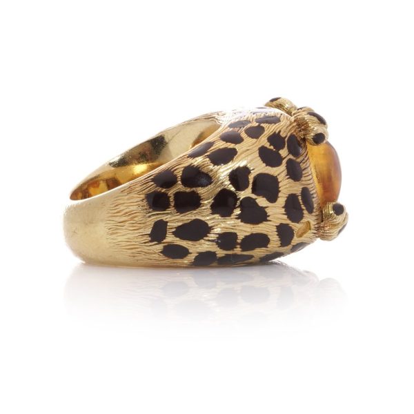 Dior cocktail ring with a sugarloaf cabochon-cut citrine, held by paw prongs in gold with black enamel leopard spots.