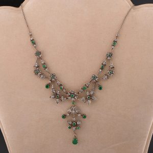 Victorian Antique Emerald and Diamond Floral Cluster Necklace, comprised of flower clusters set throughout with luxurious jungle green round and pear-cut natural emeralds and sparkling old mine-cut diamonds in silver upon 18ct gold. Circa 1870