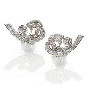 Vintage scroll design platinum earrings set with diamonds estimated total diamond weight 2.44 carats, circa 1930.
