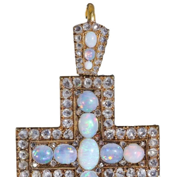 Antique 20 gold cross pendant set with diamonds and opals.