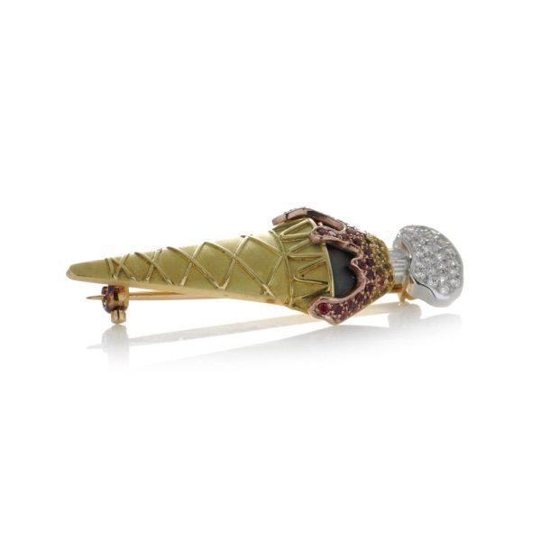 Theo Fennell gold gelato brooch set with diamonds and sapphires.