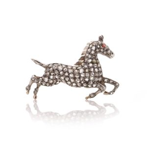 Victorian silver and gold plated horse brooch with diamonds and ruby.