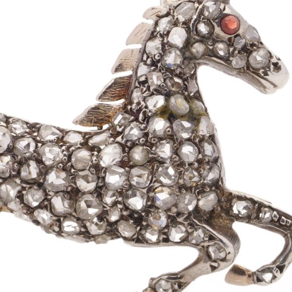 Victorian silver and gold plated horse brooch with diamonds and ruby.